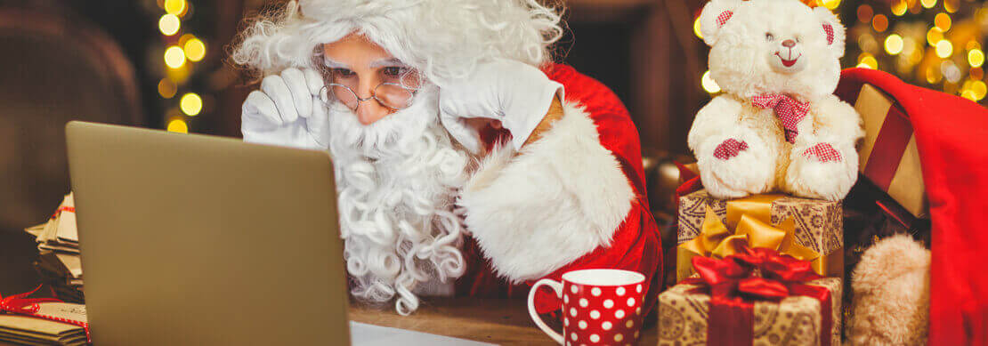 guy in Christmas attire playing on his computer