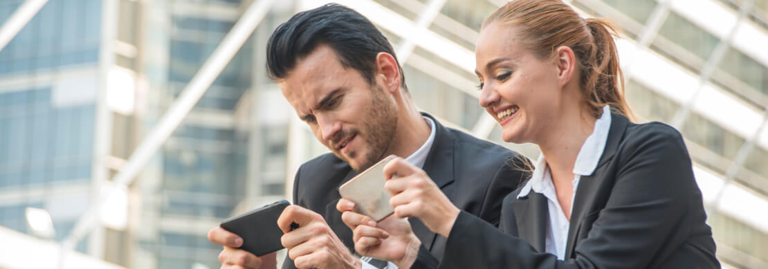 business dressed players happily playing games on their cell phones