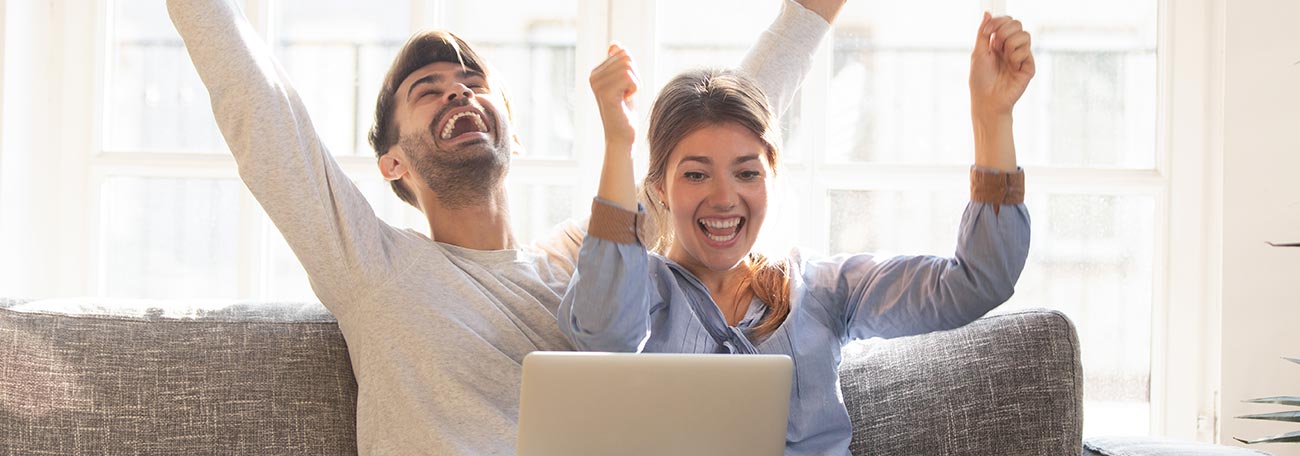 happy couple playing casino games online shows clearly the difference between gambling and gaming