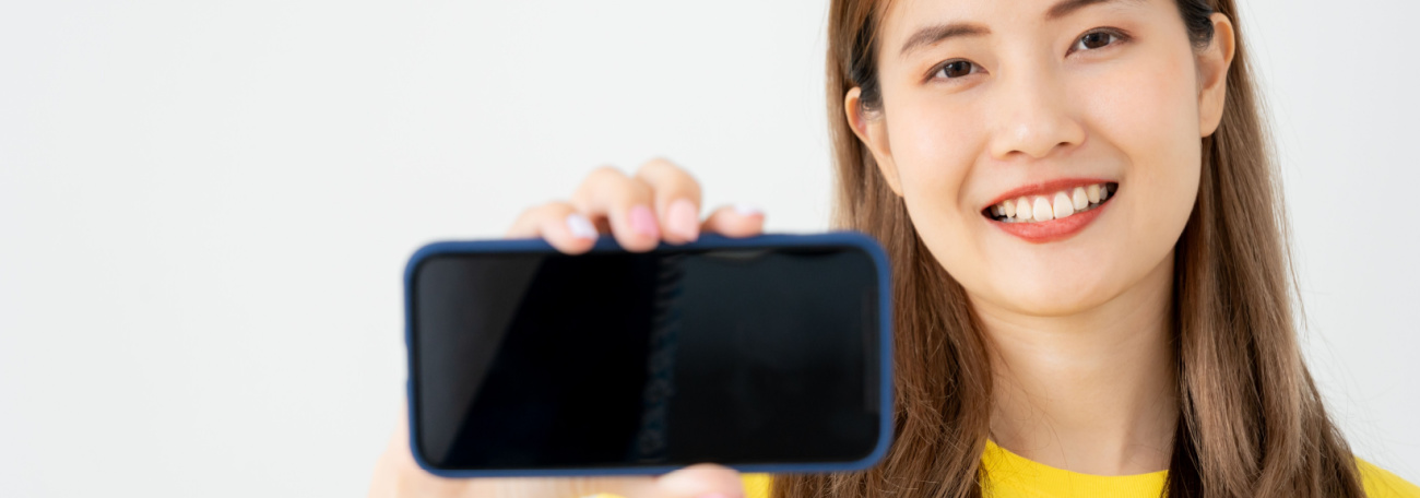 smiling young woman showing the game she is playing at an online casino