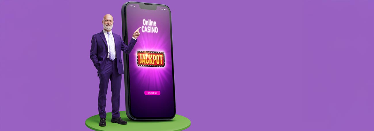 well-dressed older man with short white beard standing next to large smartphone and pointing to screen that says online casino