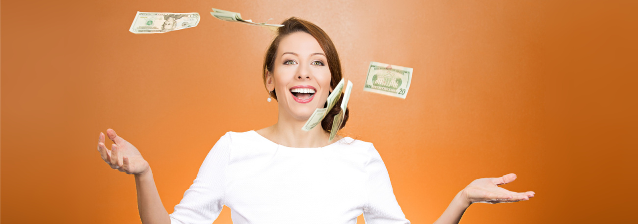 attractive young woman tossing money in the air symbolizing free casino credits