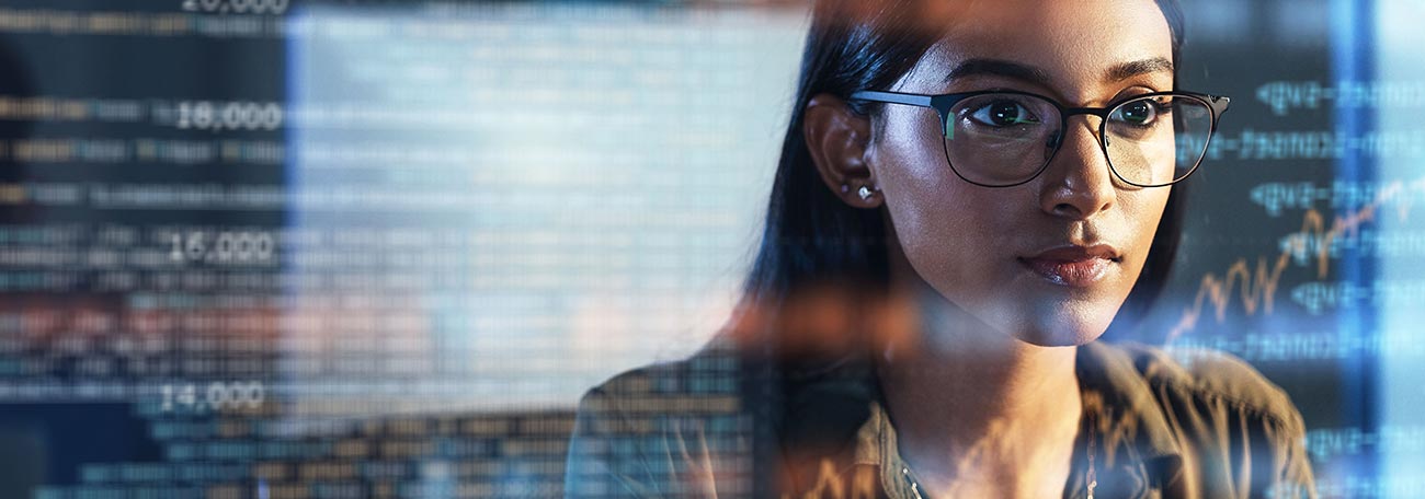 a young woman intently looking at information as if through a hologram